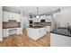 Modern kitchen with granite countertops, white cabinets, stainless steel appliances, and hardwood floors at 217 Heritage Town Pkwy, Canton, GA 30115