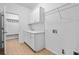 Functional laundry room with sink, cabinetry, and storage racks at 217 Heritage Town Pkwy, Canton, GA 30115