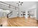 Bright living room with hardwood floors, stairs, and view into the kitchen at 217 Heritage Town Pkwy, Canton, GA 30115