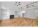 Bright living room with hardwood floors, fireplace, built-ins, stairs, and view into the kitchen at 217 Heritage Town Pkwy, Canton, GA 30115