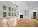 Bright living room with hardwood floors, tall windows, and fireplace with built-ins at 217 Heritage Town Pkwy, Canton, GA 30115