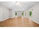 Spacious living room featuring wood floors and large windows offering wooded views at 217 Heritage Town Pkwy, Canton, GA 30115