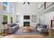 Bright living room featuring a fireplace, built-ins, and large windows for ample natural light at 217 Heritage Town Pkwy, Canton, GA 30115