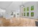 Bright living room with hardwood floors, tall windows, and a view into the kitchen and other rooms at 217 Heritage Town Pkwy, Canton, GA 30115