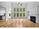 Bright living room with hardwood floors, tall windows, fireplace, and a view into the kitchen at 217 Heritage Town Pkwy, Canton, GA 30115