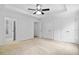 Main bedroom showcases large closets, carpet, tray ceiling and en-suite bathroom at 217 Heritage Town Pkwy, Canton, GA 30115