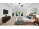 Cozy main bedroom showcasing neutral tones, decorative art, and a lounge area at 217 Heritage Town Pkwy, Canton, GA 30115