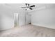 Large primary bedroom with neutral carpet, tray ceiling, and multiple doors at 217 Heritage Town Pkwy, Canton, GA 30115