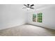 Large primary bedroom with neutral carpet, tray ceiling, and double window at 217 Heritage Town Pkwy, Canton, GA 30115