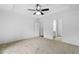 Main bedroom with neutral carpet and tray ceiling has many doors and windows at 217 Heritage Town Pkwy, Canton, GA 30115