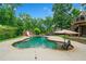 Beautiful kidney-shaped pool with a slide and ample seating area, surrounded by lush greenery at 217 Heritage Town Pkwy, Canton, GA 30115