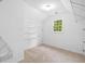 Bright walk-in closet with shelving, carpet floors, and a window for natural light at 217 Heritage Town Pkwy, Canton, GA 30115