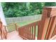 Wooden back deck overlooking a lush green backyard with a tall wood privacy fence and mature trees at 3302 Bellingham Way, Lithia Springs, GA 30122