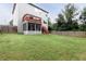 A spacious backyard featuring a wooden deck, screened porch, and full privacy fence, offering a private outdoor space at 3302 Bellingham Way, Lithia Springs, GA 30122