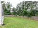 Backyard with tall privacy fence and mature trees at 3302 Bellingham Way, Lithia Springs, GA 30122