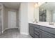 Bathroom with double vanity, gray cabinets, and gray tile flooring at 3302 Bellingham Way, Lithia Springs, GA 30122