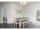 Inviting dining area features wainscoting, stylish lighting, and natural light at 3302 Bellingham Way, Lithia Springs, GA 30122