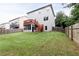 Exterior view of the home showcasing a spacious backyard, deck, screened porch, and full privacy fence at 3302 Bellingham Way, Lithia Springs, GA 30122