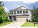 Charming two-story home features a manicured lawn and neutral siding with black shutters at 3302 Bellingham Way, Lithia Springs, GA 30122