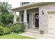Inviting front porch with brick columns and lush landscaping at 3302 Bellingham Way, Lithia Springs, GA 30122