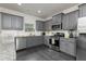 Well-equipped kitchen with gray cabinetry, stainless steel appliances, granite countertops, and dark wood-look flooring at 3302 Bellingham Way, Lithia Springs, GA 30122