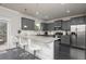 Updated kitchen with stainless steel appliances, granite countertops, and gray cabinets at 3302 Bellingham Way, Lithia Springs, GA 30122