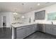Kitchen featuring granite countertops, gray cabinetry, stainless steel appliances, and open floor plan at 3302 Bellingham Way, Lithia Springs, GA 30122