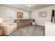 Cozy living room featuring neutral tones, plush seating, and natural light through bright windows at 3302 Bellingham Way, Lithia Springs, GA 30122