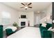 Bright living room featuring a fireplace, ceiling fan, and hardwood floors at 3302 Bellingham Way, Lithia Springs, GA 30122