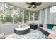 Relaxing screened porch featuring comfortable seating, decorative pillows, and tranquil views at 3302 Bellingham Way, Lithia Springs, GA 30122