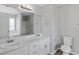 Bathroom featuring dual sinks with chrome faucets, white cabinets, toilet and tub with shower at 341 Windermere Dr., Loganville, GA 30052