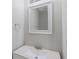 Bathroom featuring single sink with chrome faucet, white cabinet and framed mirror at 341 Windermere Dr., Loganville, GA 30052