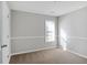 This bedroom offers plush carpeting and natural light, creating a cozy and inviting space at 341 Windermere Dr., Loganville, GA 30052
