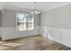 Dining room featuring modern chandelier, window, wood trim and neutral color palette at 341 Windermere Dr., Loganville, GA 30052