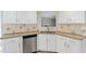 Kitchen featuring stone countertops, stainless steel dishwasher, white cabinetry and decorative backsplash at 341 Windermere Dr., Loganville, GA 30052