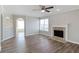 Bright living room featuring hardwood floors, a decorative fireplace, ceiling fan and neutral paint at 341 Windermere Dr., Loganville, GA 30052
