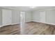 Open living room with wood-look floors and a view into the next room, enhancing the space at 341 Windermere Dr., Loganville, GA 30052