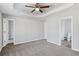 Spacious main bedroom featuring a tray ceiling, ceiling fan, carpet and ensuite bathroom at 341 Windermere Dr., Loganville, GA 30052