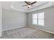 Spacious main bedroom featuring a tray ceiling, ceiling fan, carpet and lots of natural light at 341 Windermere Dr., Loganville, GA 30052