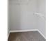Bright walk-in closet with neutral carpeting and white shelving for optimal storage at 341 Windermere Dr., Loganville, GA 30052