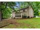 View of the home's backyard with large trees and a fenced perimeter at 133 Sw Patterson Rd, Lawrenceville, GA 30044