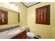 Bathroom with vanity, granite countertops, and window shutter at 133 Sw Patterson Rd, Lawrenceville, GA 30044