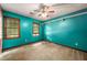 Inviting bedroom featuring bright teal walls, window views, and a ceiling fan at 133 Sw Patterson Rd, Lawrenceville, GA 30044