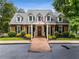 Charming brick home featuring dormer windows and a welcoming front yard at 133 Sw Patterson Rd, Lawrenceville, GA 30044