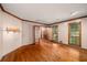 Bright living room featuring hardwood floors, wood trim and large windows with natural light at 133 Sw Patterson Rd, Lawrenceville, GA 30044