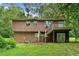 This home features a deck, a staircase and back door with access to the backyard at 1991 Flat Shoals Rd, Riverdale, GA 30296