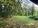 Spacious backyard featuring mature trees and lush greenery, offering a serene and private outdoor space at 1991 Flat Shoals Rd, Riverdale, GA 30296