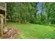 Expansive backyard with mature trees and a sprawling lawn, perfect for outdoor activities and relaxation at 1991 Flat Shoals Rd, Riverdale, GA 30296
