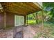 Basement exterior entrance of home with double doors and wood siding plus concrete porch and yard space at 1991 Flat Shoals Rd, Riverdale, GA 30296