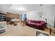 Spacious carpeted basement featuring a comfortable sofa and a brick wall at 1991 Flat Shoals Rd, Riverdale, GA 30296